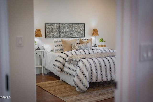 bedroom with dark wood-type flooring