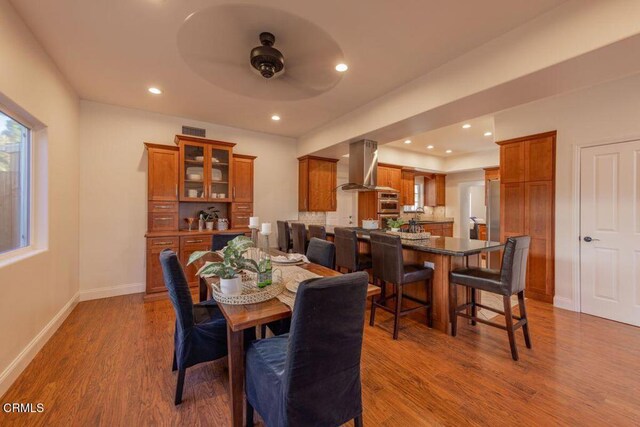 dining room featuring ceiling fan and wood-type flooring