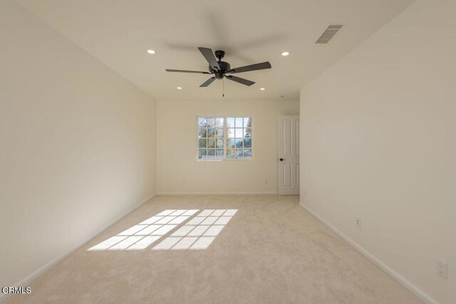 carpeted empty room featuring ceiling fan