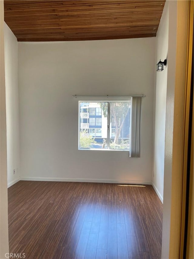 empty room featuring wood ceiling and dark hardwood / wood-style floors