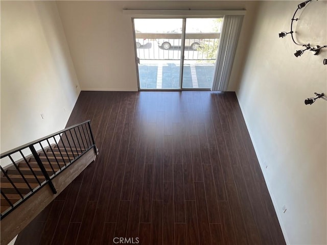 unfurnished room featuring dark wood-type flooring