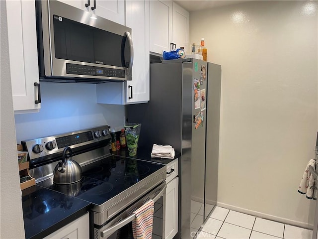 kitchen featuring white cabinetry, light tile patterned floors, and stainless steel appliances