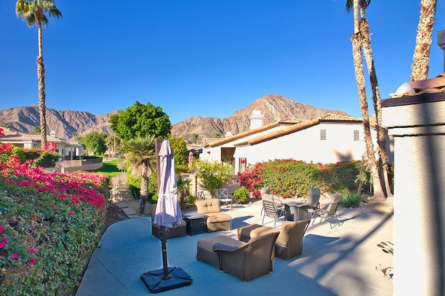 view of patio with a mountain view and an outdoor living space