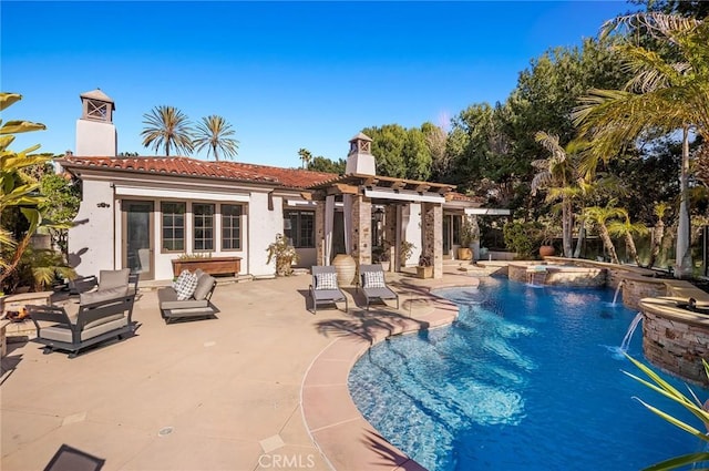 view of pool with an in ground hot tub, pool water feature, and a patio