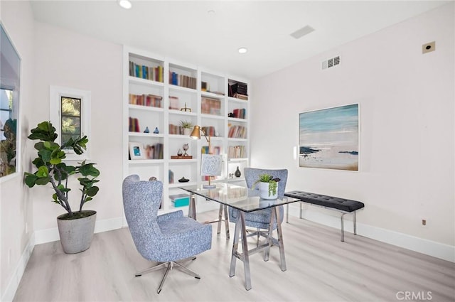 office space with light wood-type flooring