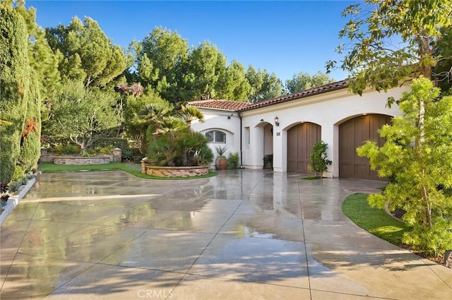 mediterranean / spanish-style home featuring a garage