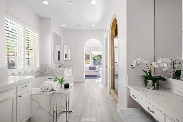 interior space featuring hardwood / wood-style floors, vanity, and a healthy amount of sunlight