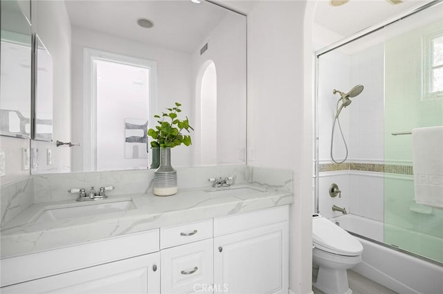 full bathroom featuring vanity, toilet, and enclosed tub / shower combo