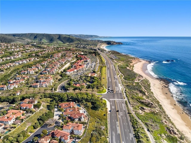 birds eye view of property with a water view and a view of the beach