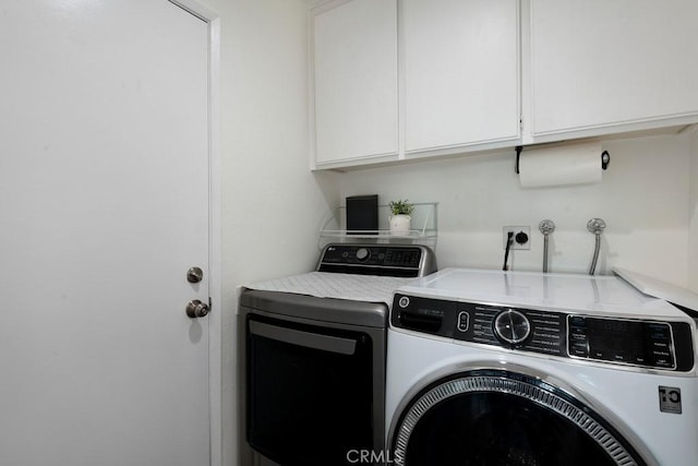 laundry area featuring cabinets and independent washer and dryer