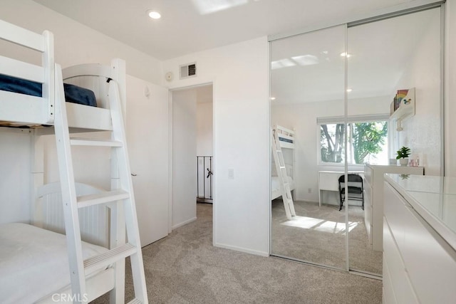 unfurnished bedroom featuring light colored carpet and a closet