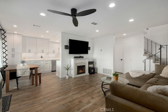 living room with ceiling fan and wood-type flooring