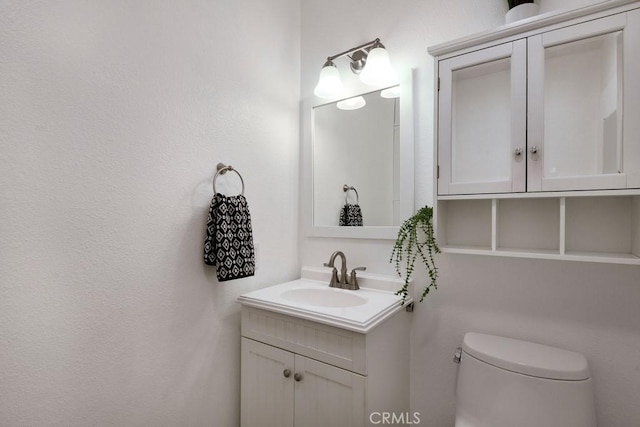 bathroom with toilet and vanity