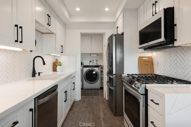 kitchen featuring light stone countertops, stainless steel appliances, white cabinets, and sink