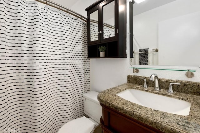 bathroom featuring curtained shower, toilet, and vanity