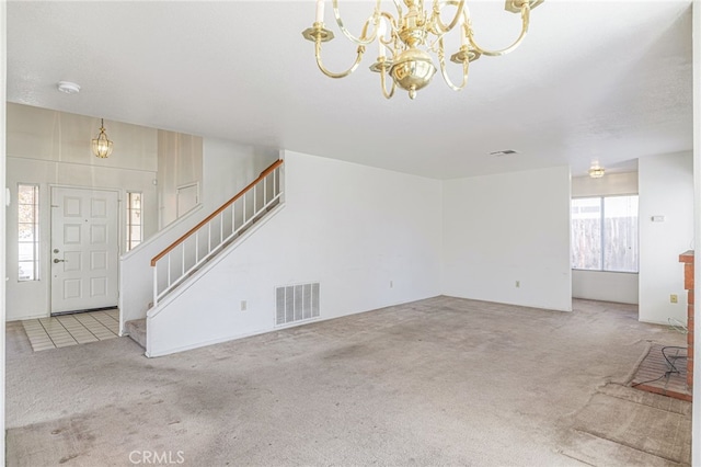 unfurnished living room with carpet floors and a notable chandelier