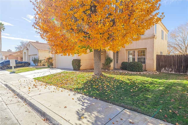 view of property hidden behind natural elements with a front yard and a garage