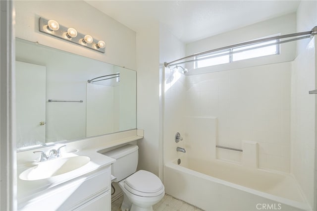 full bathroom featuring vanity, tiled shower / bath combo, and toilet