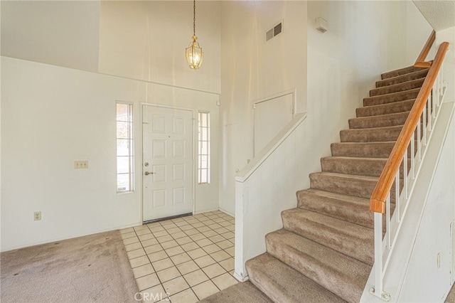 tiled entryway with a high ceiling