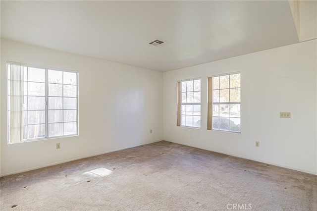 unfurnished room with light carpet