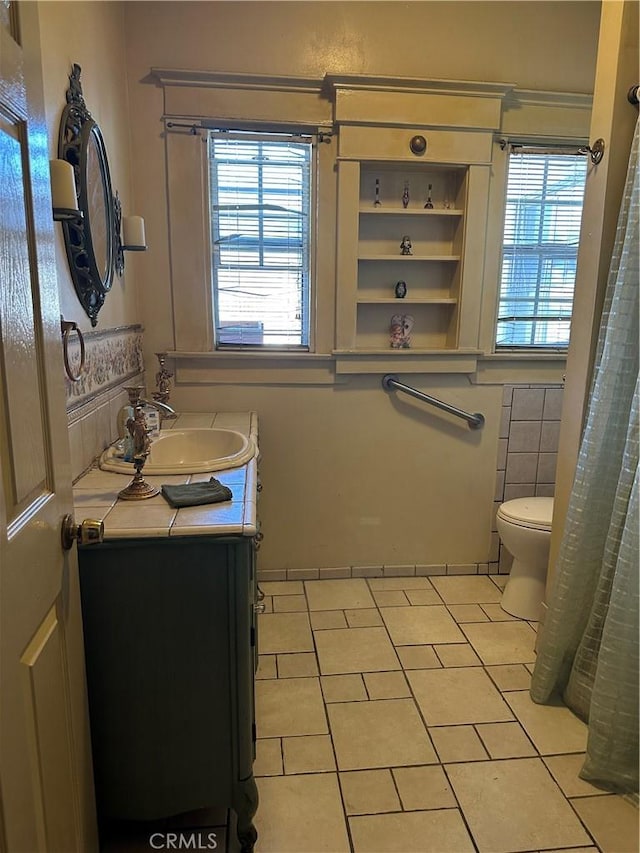 bathroom featuring tile patterned flooring, vanity, and plenty of natural light