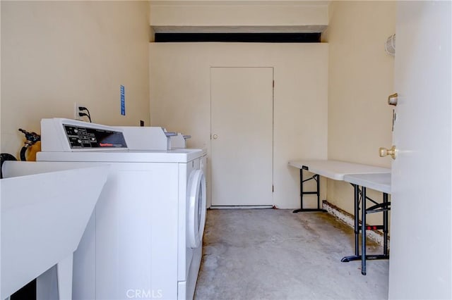 laundry area featuring washing machine and dryer and sink