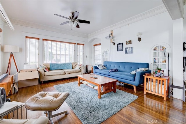 living room featuring dark hardwood / wood-style floors, ceiling fan, and ornamental molding