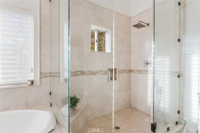 bathroom featuring separate shower and tub