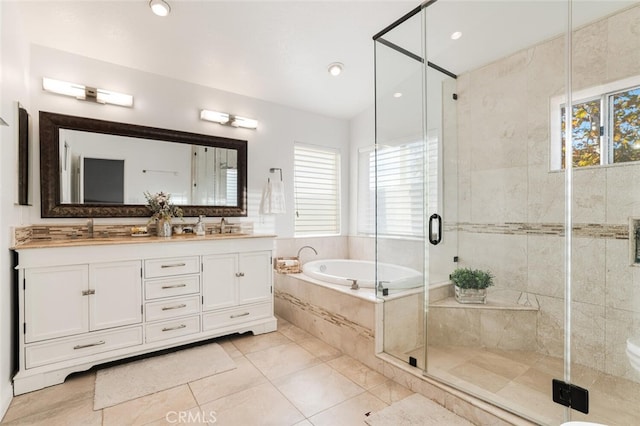 bathroom with plus walk in shower, vanity, and plenty of natural light