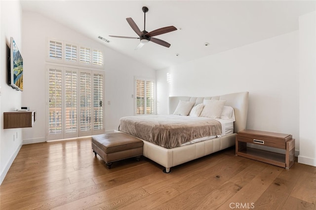 bedroom featuring ceiling fan, access to exterior, light wood-type flooring, and vaulted ceiling