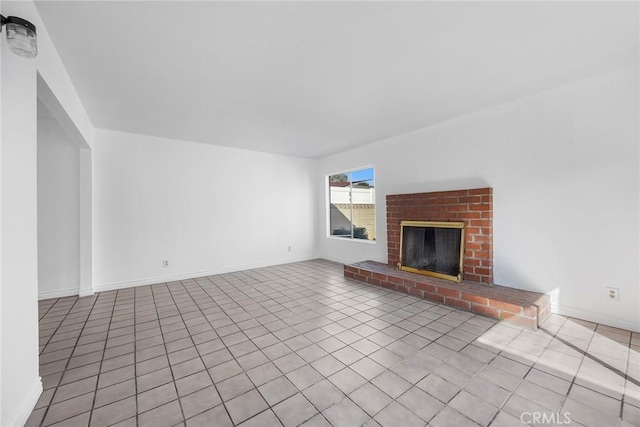 unfurnished living room with light tile patterned floors and a fireplace