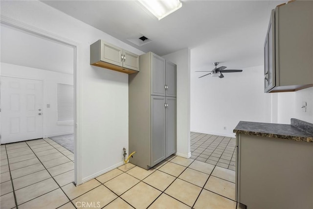 kitchen with ceiling fan, gray cabinets, and light tile patterned flooring