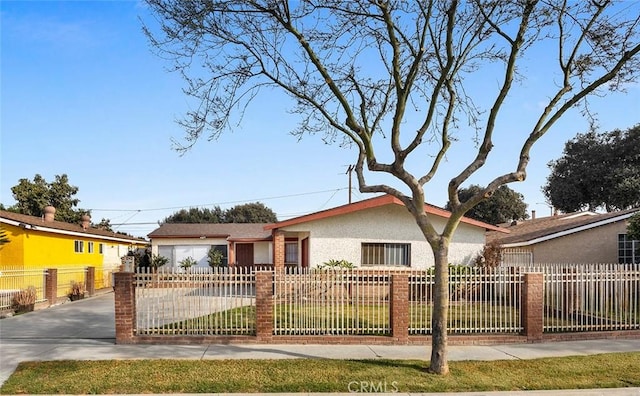 ranch-style home featuring a front yard and a garage