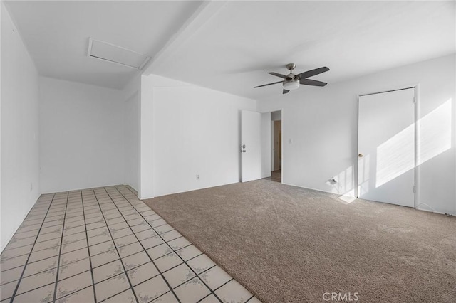 carpeted spare room featuring ceiling fan