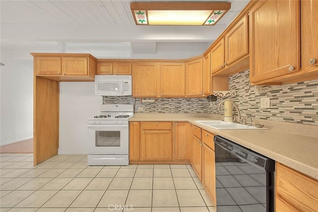 kitchen with backsplash, sink, light tile patterned floors, and white appliances