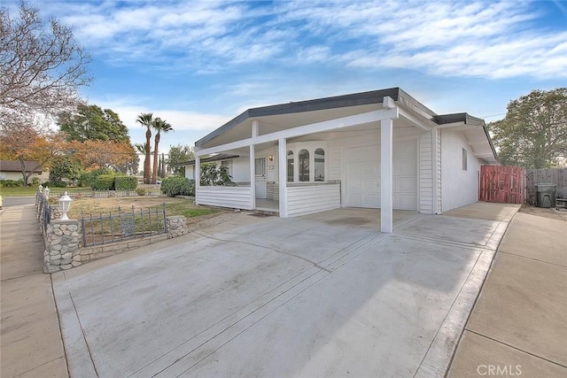 view of front of property with a porch and a garage