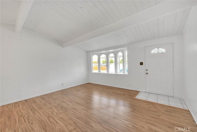 foyer with beamed ceiling and light wood-type flooring