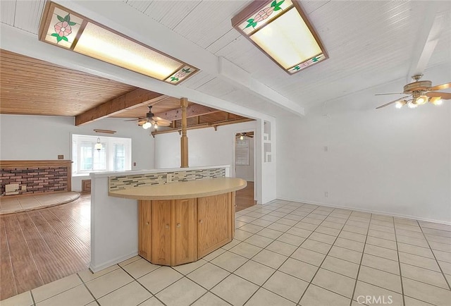 kitchen featuring wooden ceiling, backsplash, vaulted ceiling with beams, ceiling fan, and light hardwood / wood-style floors