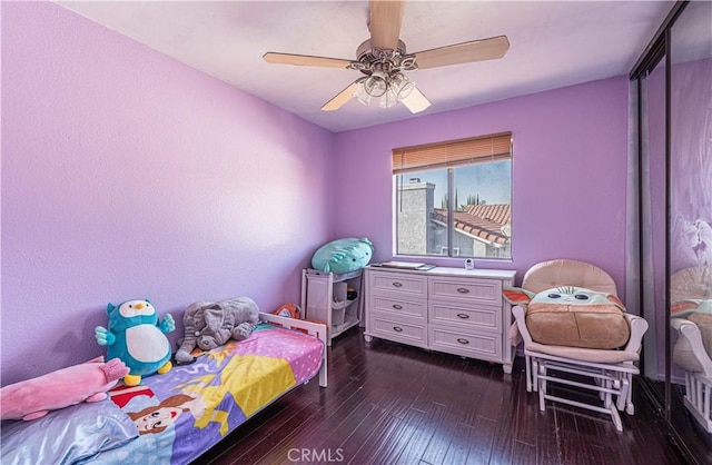 bedroom featuring ceiling fan and dark hardwood / wood-style floors