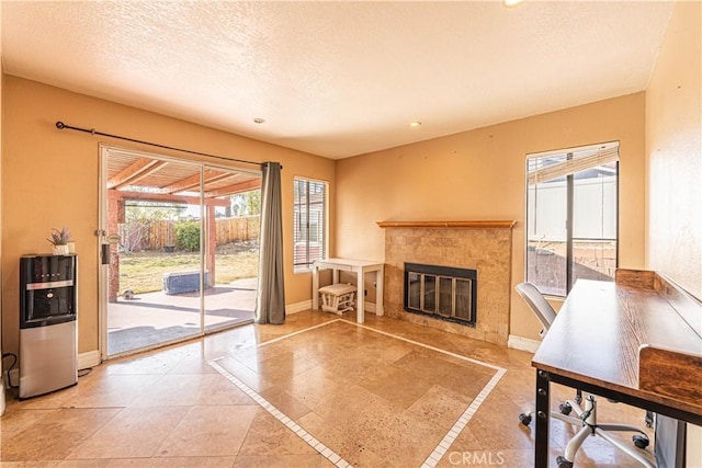 living room featuring a tile fireplace and a textured ceiling