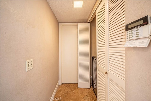 hall with a textured ceiling