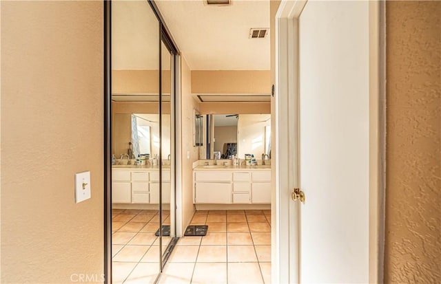 bathroom with tile patterned floors and vanity