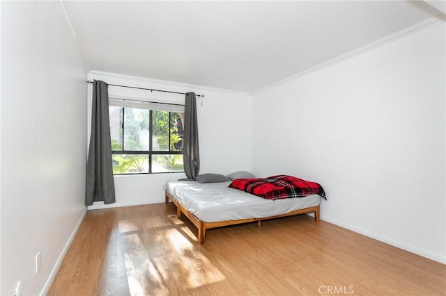 22100 Burbank Blvd Unit 106A, Woodland Hills, CA 91367 - bedroom with baseboards, crown molding, and light wood-style floors