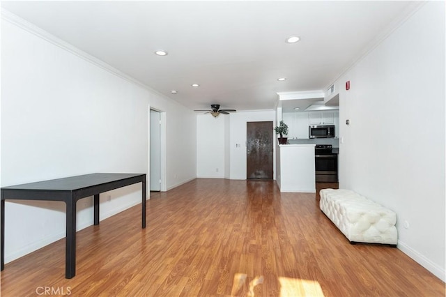 living room featuring light wood-type flooring, ceiling fan, and ornamental molding