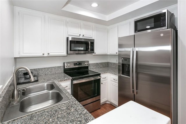 22100 Burbank Blvd Unit 106A, Woodland Hills, CA 91367 - kitchen with white cabinets, stainless steel appliances, a sink, recessed lighting, and wood finished floors