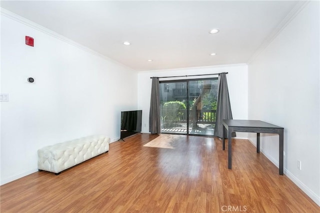 unfurnished living room with crown molding and light hardwood / wood-style floors