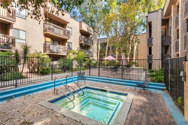 view of pool with a community hot tub