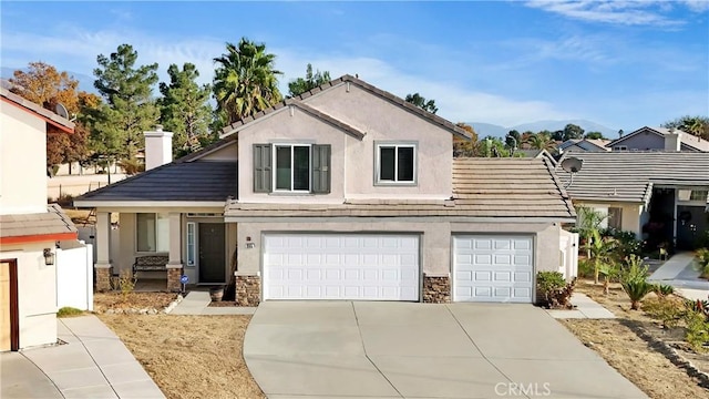 view of front facade featuring a garage and a mountain view