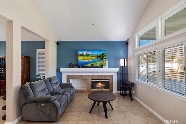 living room with light tile patterned floors, lofted ceiling, and a fireplace