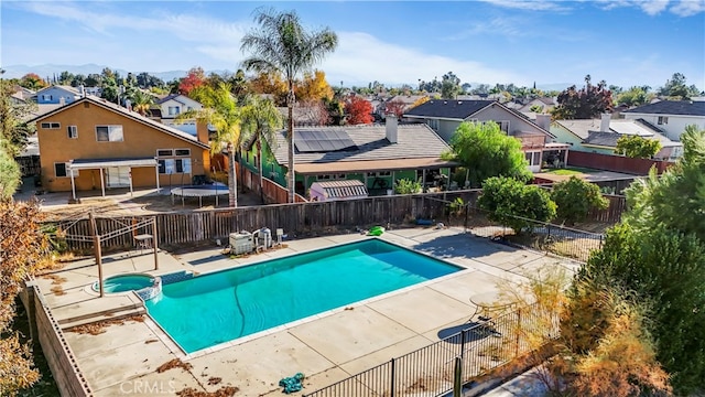 view of pool featuring a trampoline, a patio area, and a mountain view